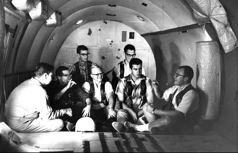 seven members of the Gaudet 11 having a chat before their zero gravity flight